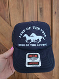 Navy Trucker cap with mesh back featuring white land of the free home of the cowboy horse detailing
