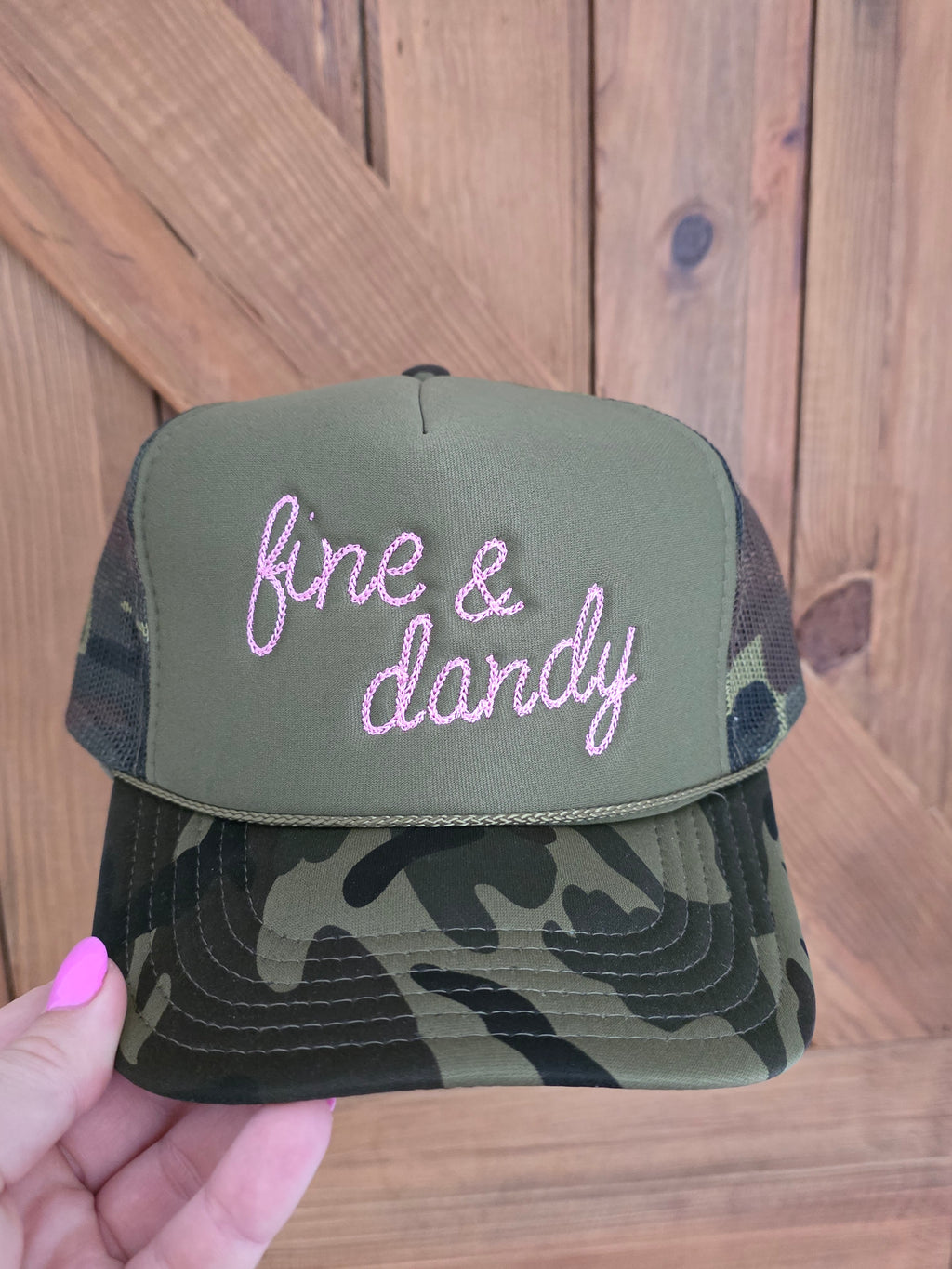 Five panel camo trucker cap with pink fine and dandy front embroidery and rope detailing