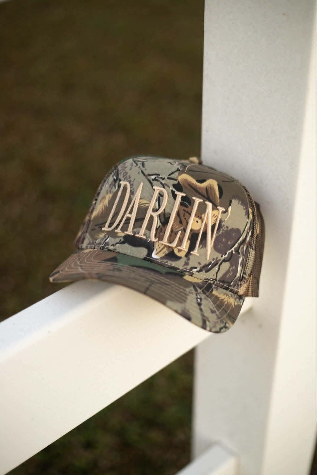 Stylish camo baseball cap with bold embroidered "Darlin" text in cream stitching
