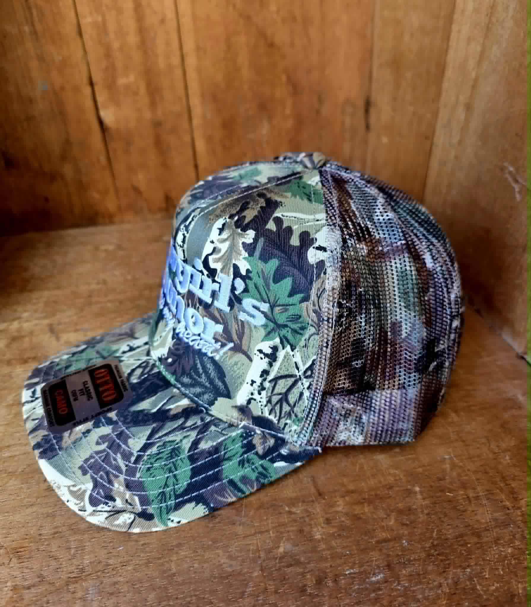 Country western mesh back cap in the leafy camo print with "Cowgirls Honor Cross my heart" stitched across the front. Adjustable snapback style made for concerts, markets, and road trips