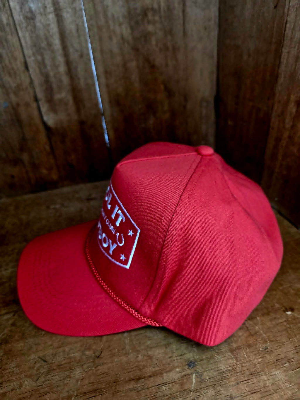 Statement red cowboy trucker cap with crisp white embroidered "Cool It Cowboy" design, cowgirls only club detailing, and retro western aesthetic ideal for festival fashion and everyday country wear