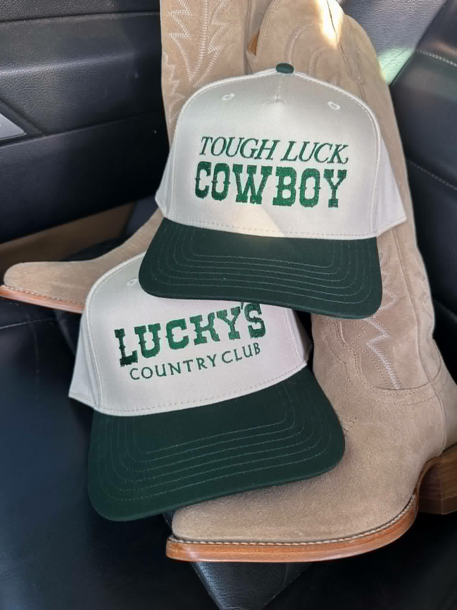 Western trucker cap featuring green TOUGH LUCK COWBOY embroidery