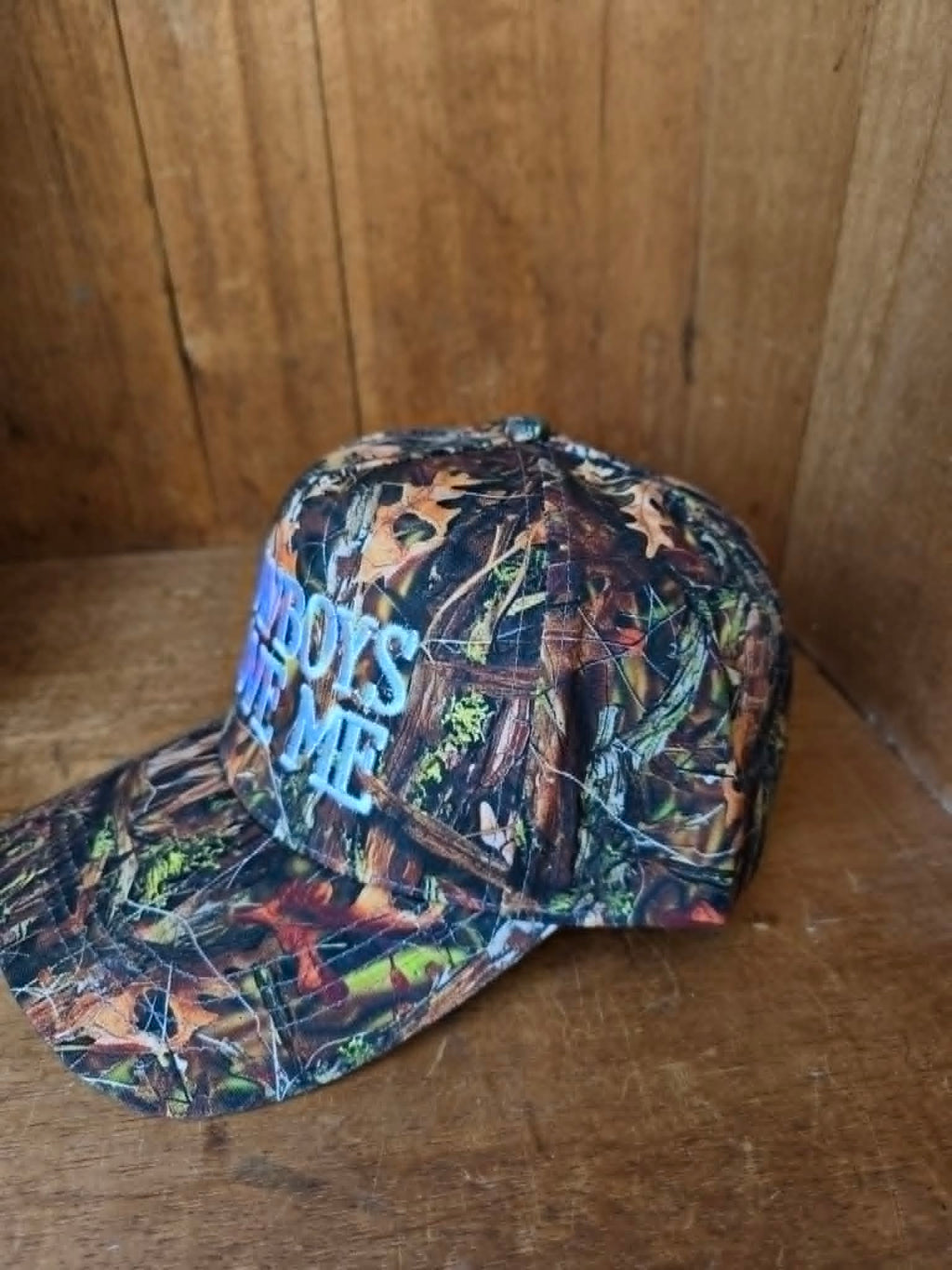 Vintage inspired camouflage cap with bold cowboy slogan embroidery blending western streetwear vibes with classic country fashion
