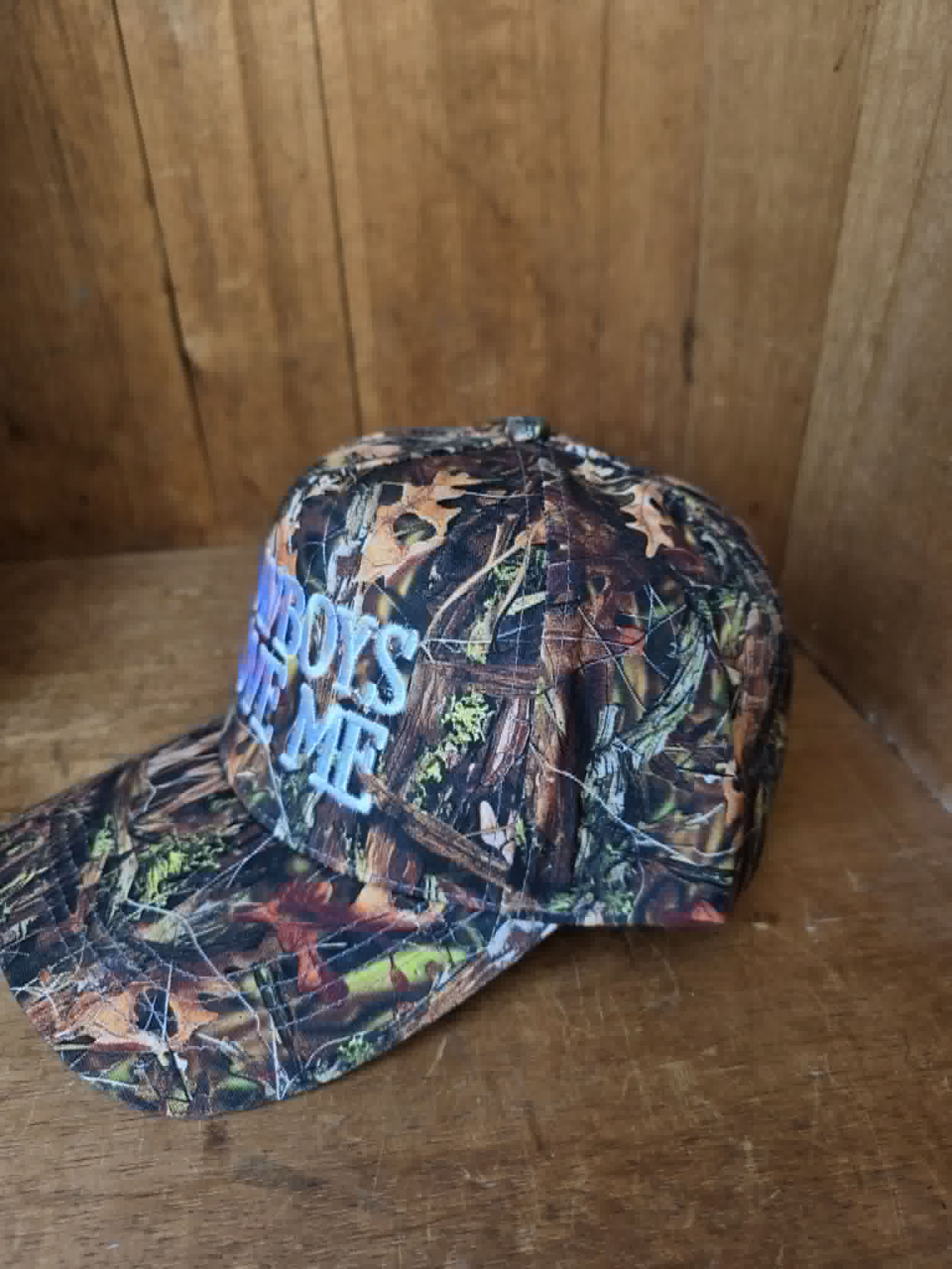 Vintage inspired camouflage cap with bold cowboy slogan embroidery blending western streetwear vibes with classic country fashion